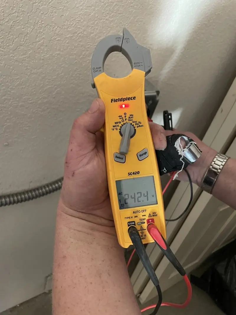 Voltage testing with clamp meter during Recessed Lighting Installation in Central Park